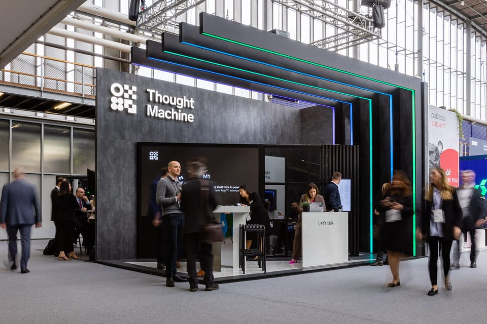 Thought Machine conference stand with lit gradient fins